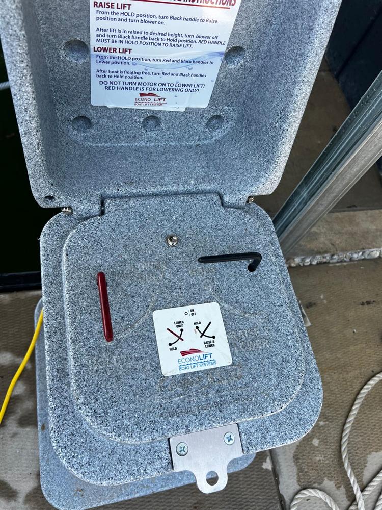 Econo Lift control box with red and black handles and raise and lower instructions